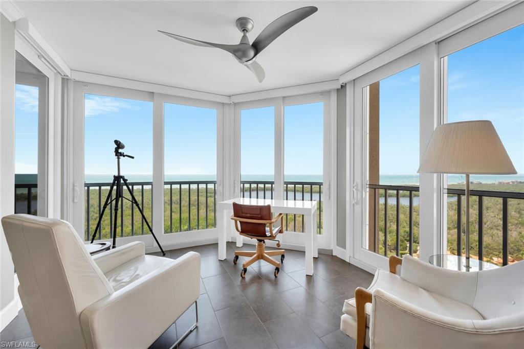 a living room with furniture and a floor to ceiling window