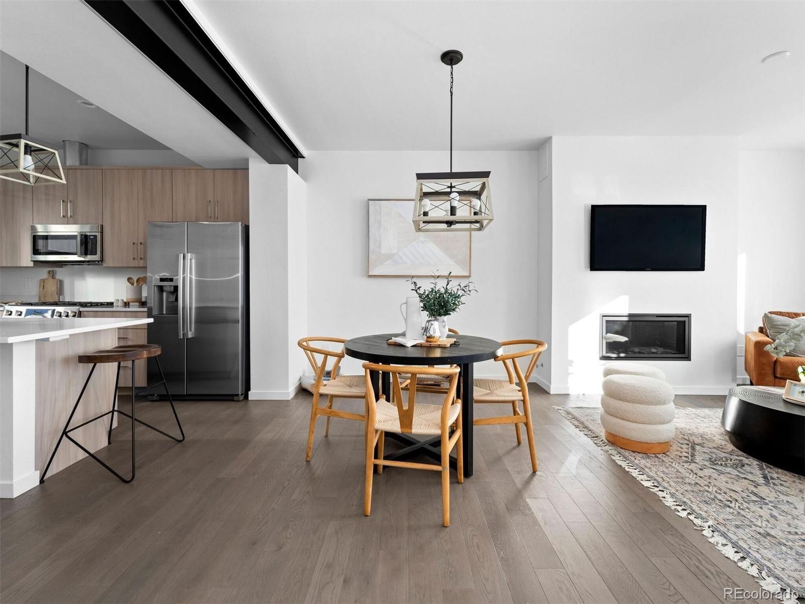 a dining room with furniture a chandelier and wooden floor