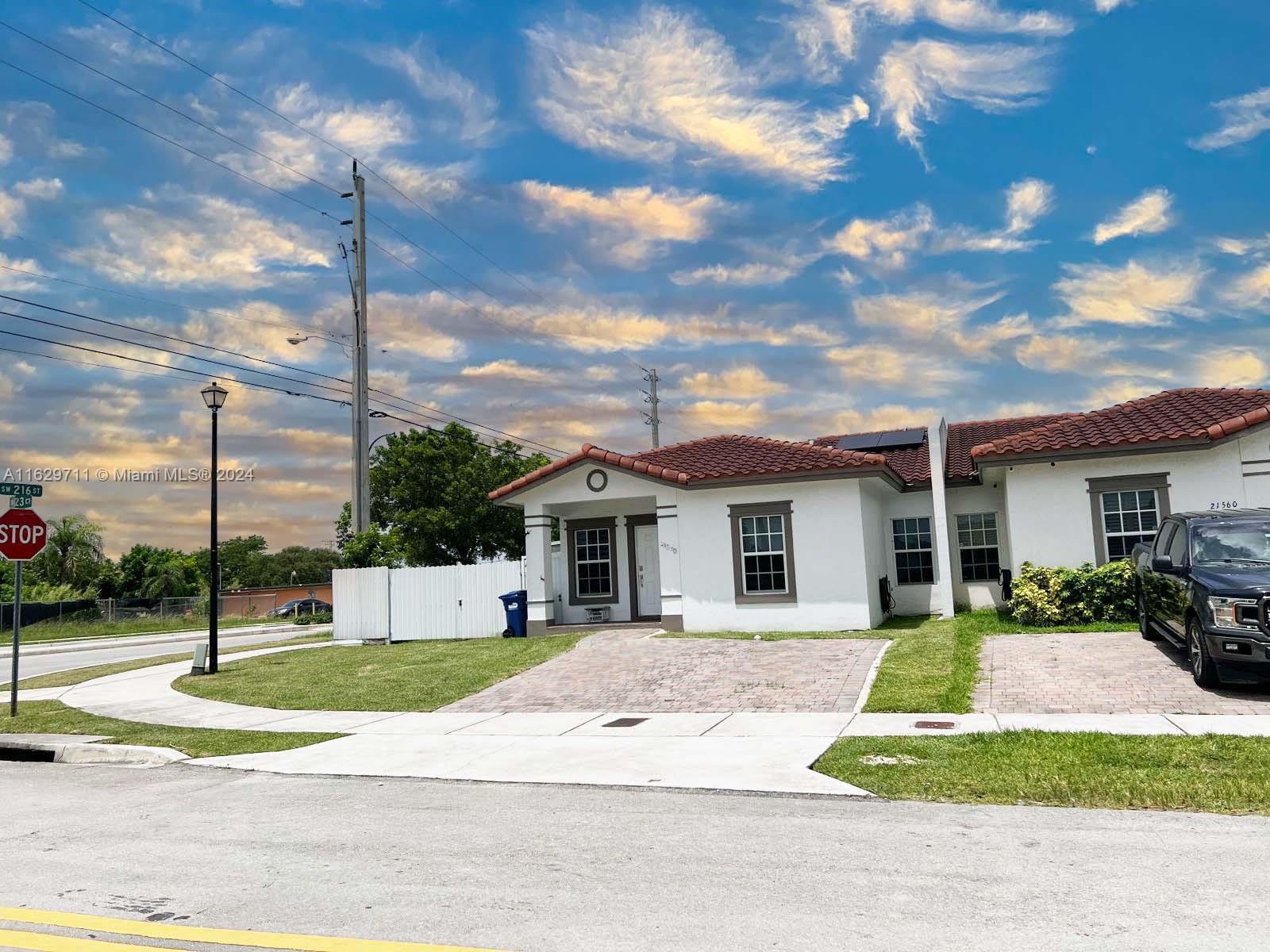 a view of a house with a backyard