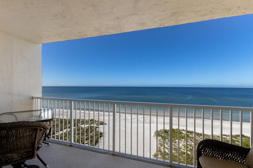 a view of a balcony with furniture