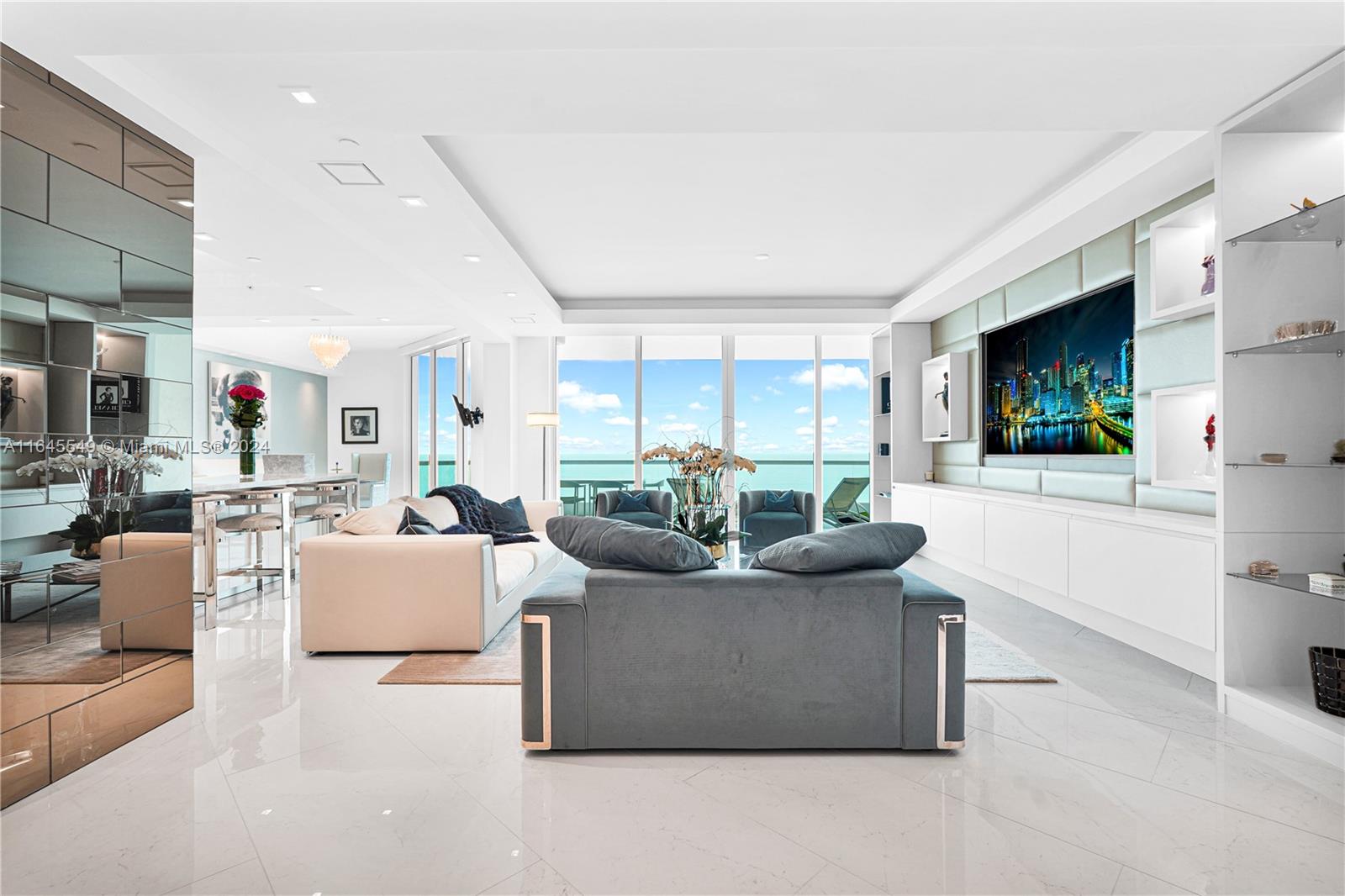 a living room with furniture a flat screen tv and a large window