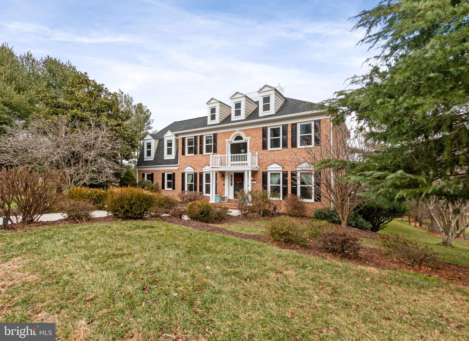 a house that has a lot of plants and trees in the background