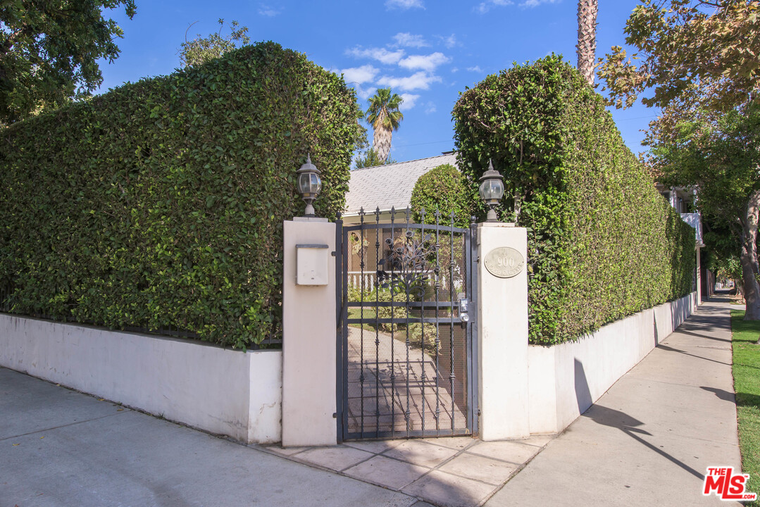 a view of a entrance gate of the house and trees