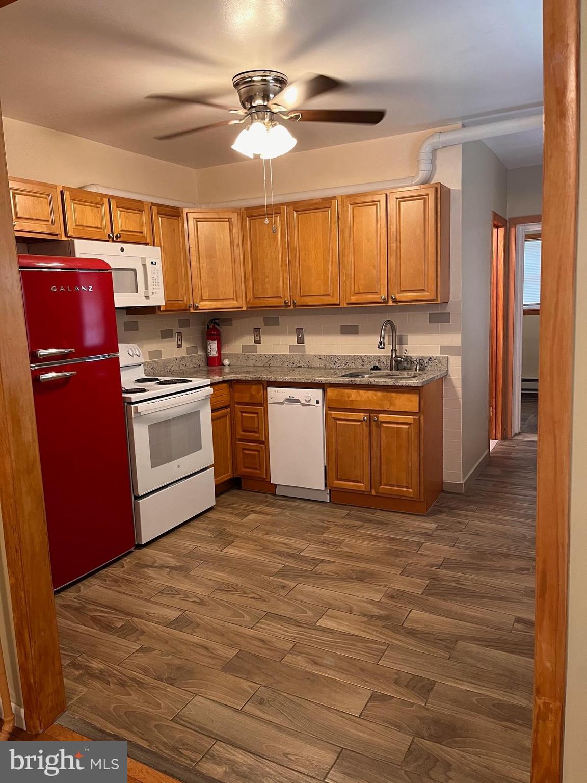 a kitchen with stainless steel appliances granite countertop a stove top oven a sink and dishwasher