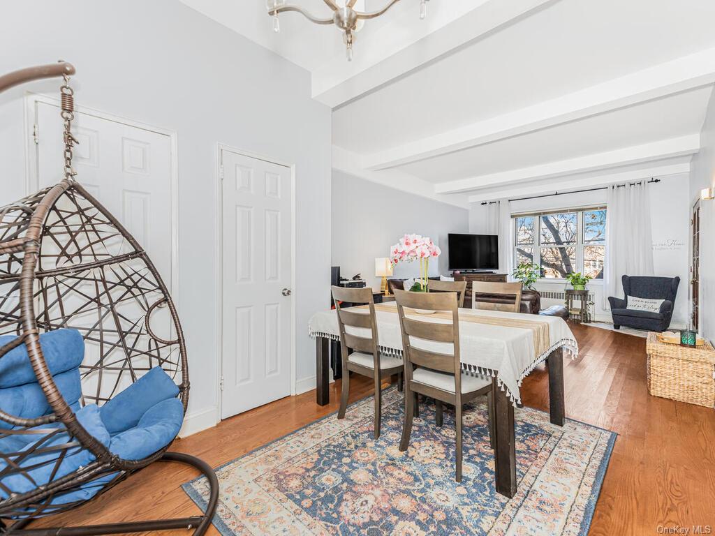 Dining space featuring beamed ceiling and hardwood / wood-style flooring