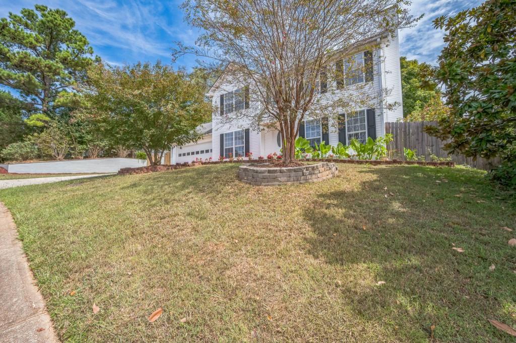 a brick house with trees in front of it