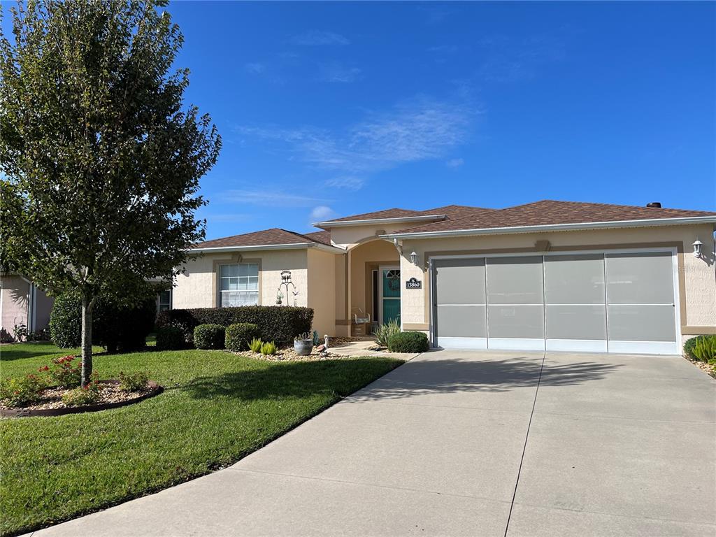 a front view of a house with a yard and garage