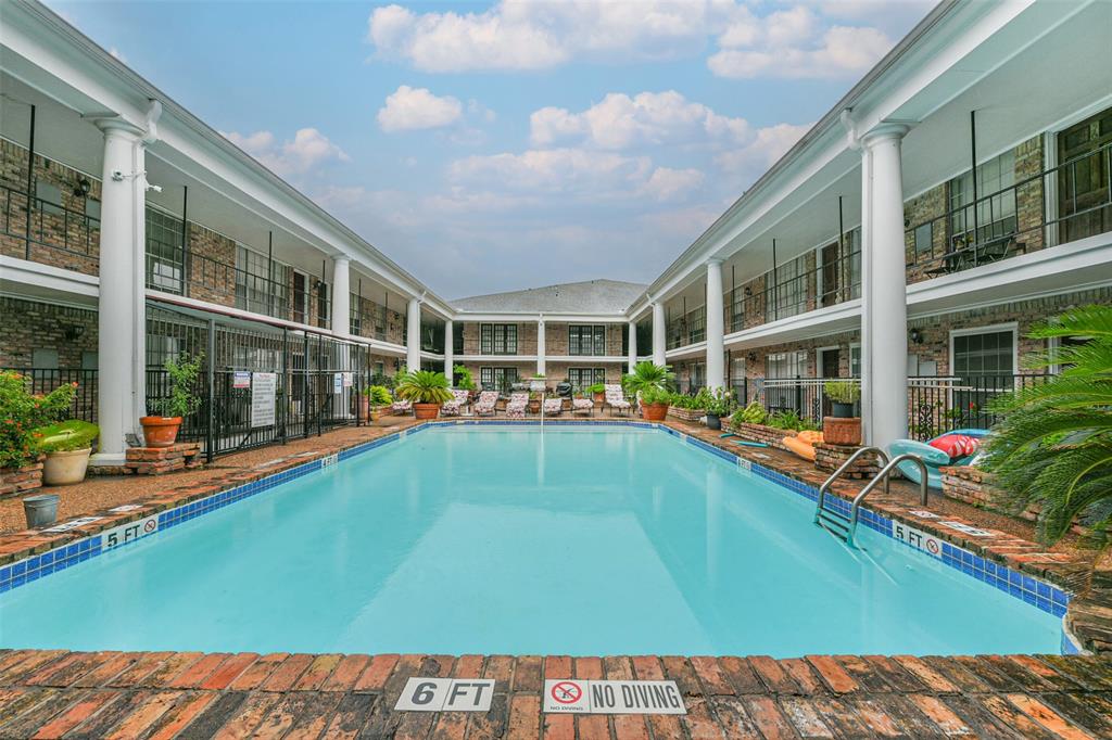 a view of swimming pool with outdoor seating