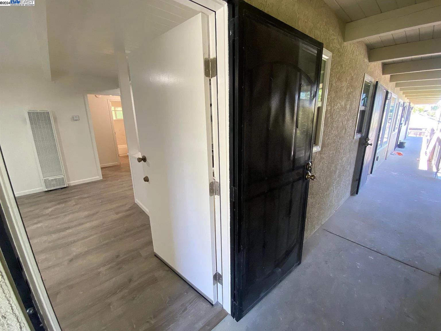 a view of a hallway with wooden floor