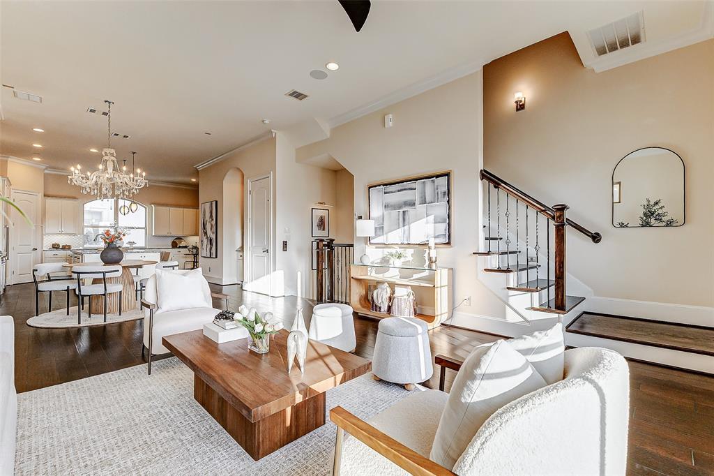 a living room with furniture and a dining table