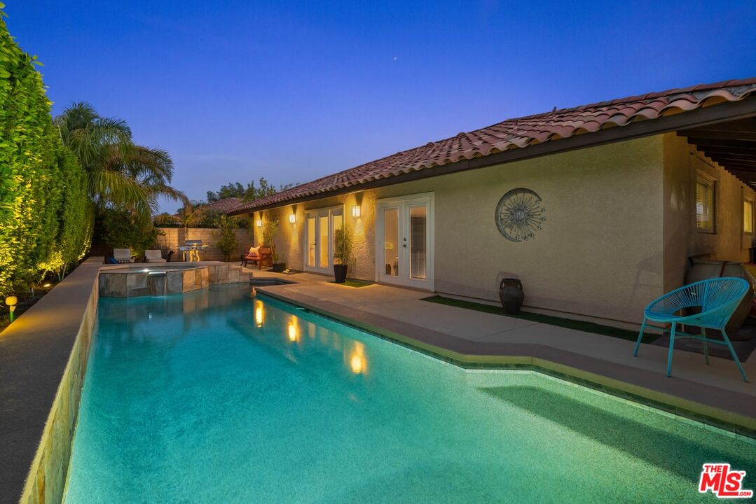 a swimming pool with outdoor seating and yard