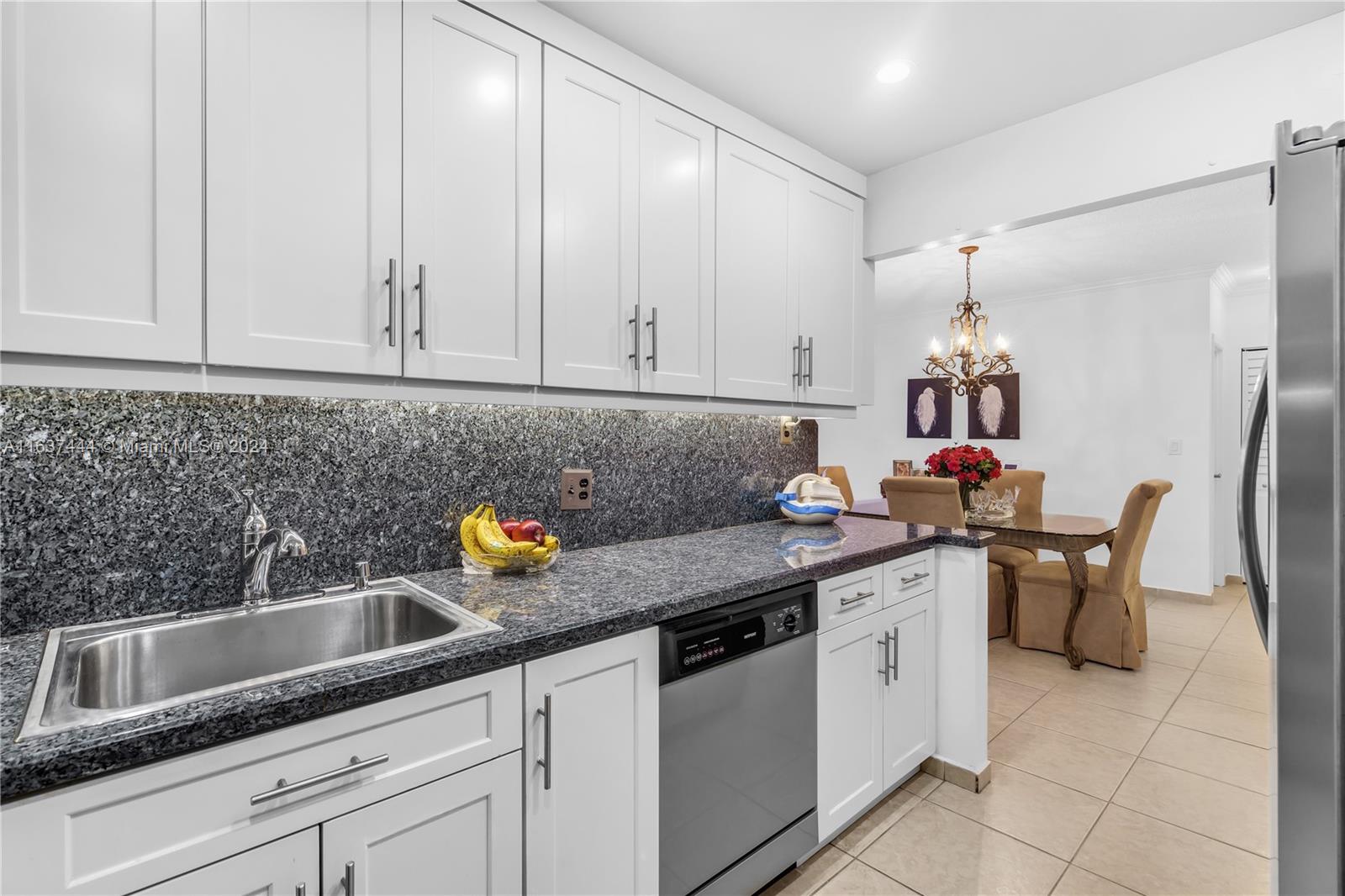 a kitchen with stainless steel appliances granite countertop a sink and cabinets