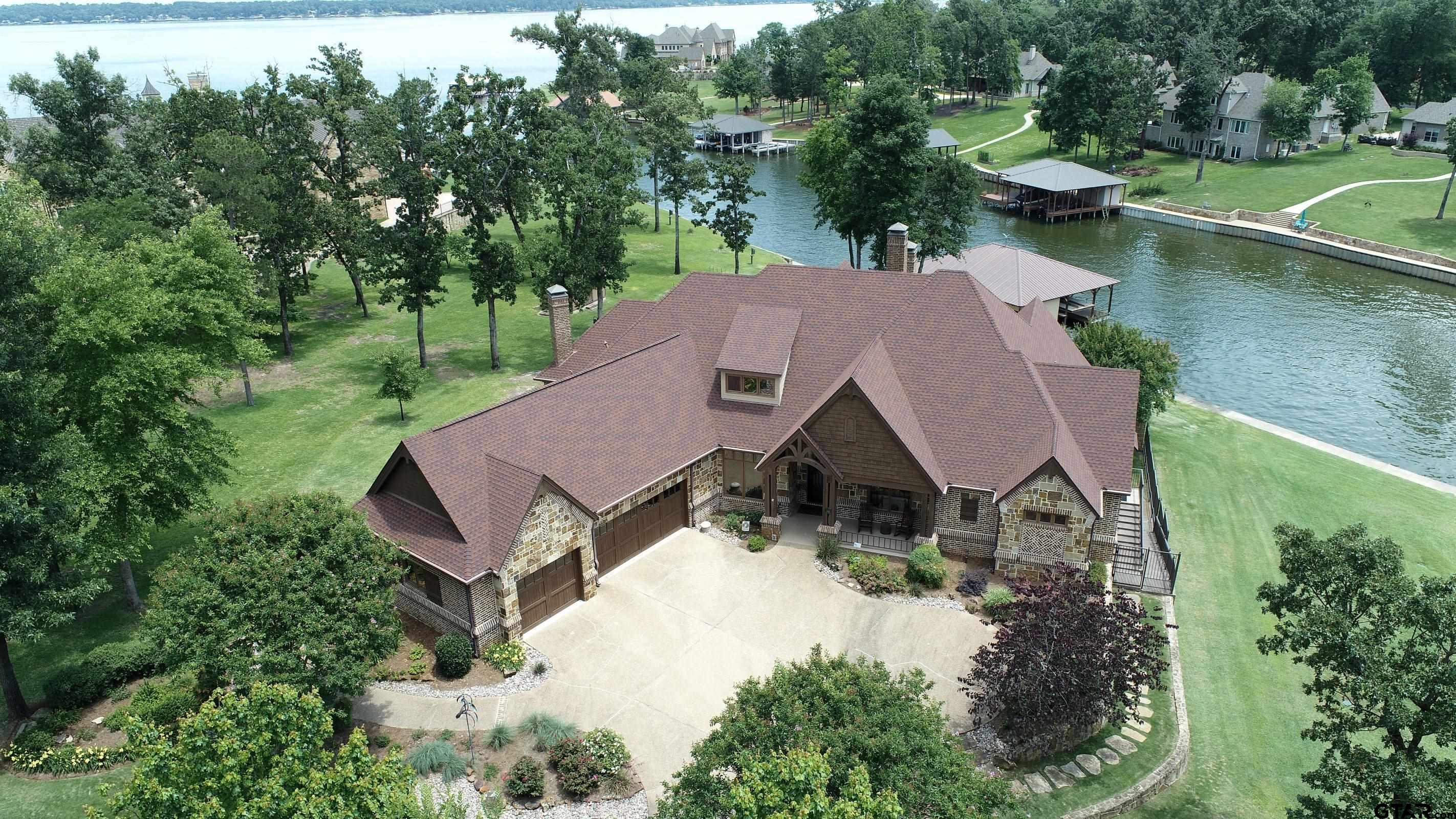 an aerial view of a house with swimming pool and garden