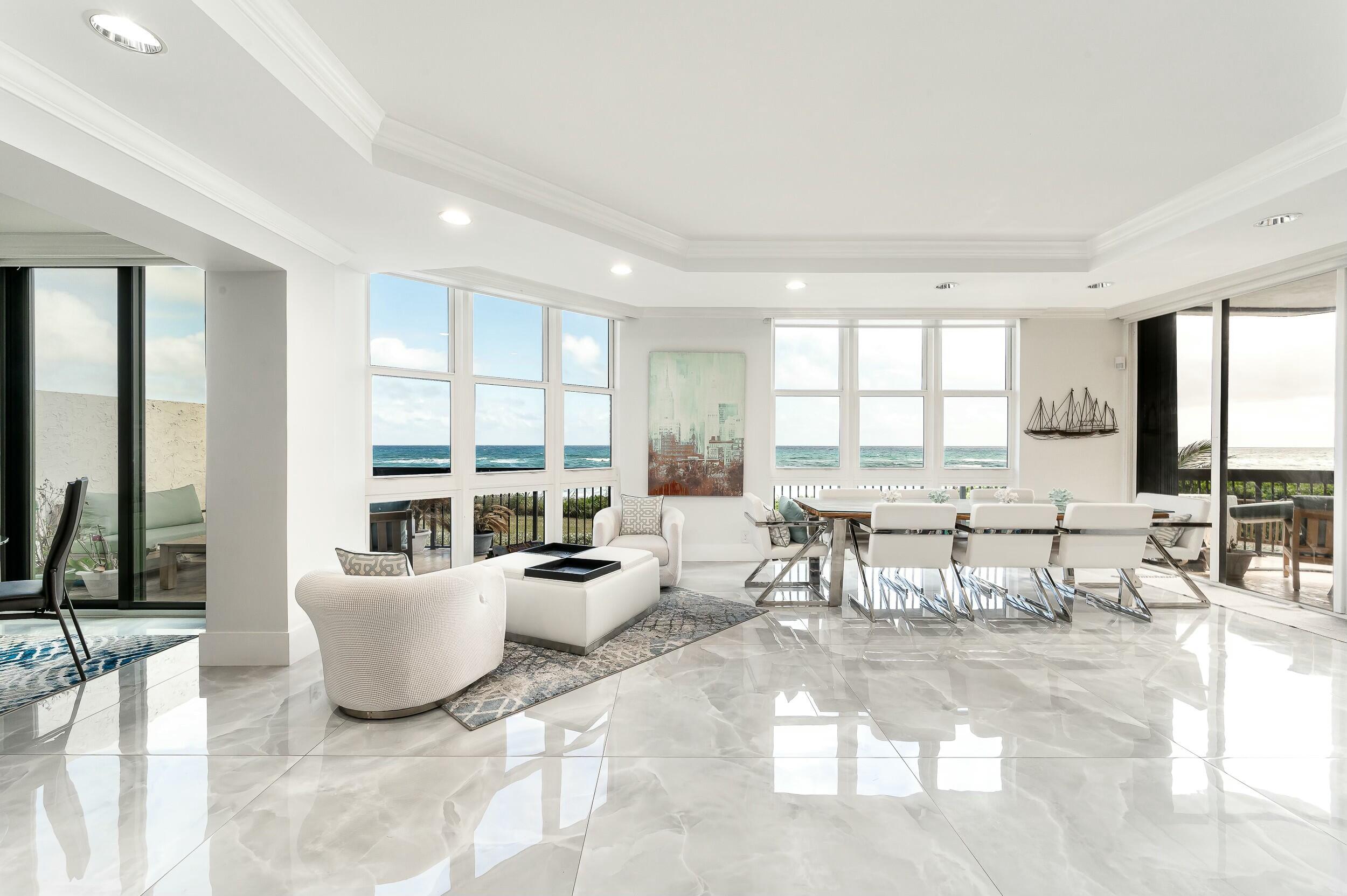 a living room with furniture and large windows