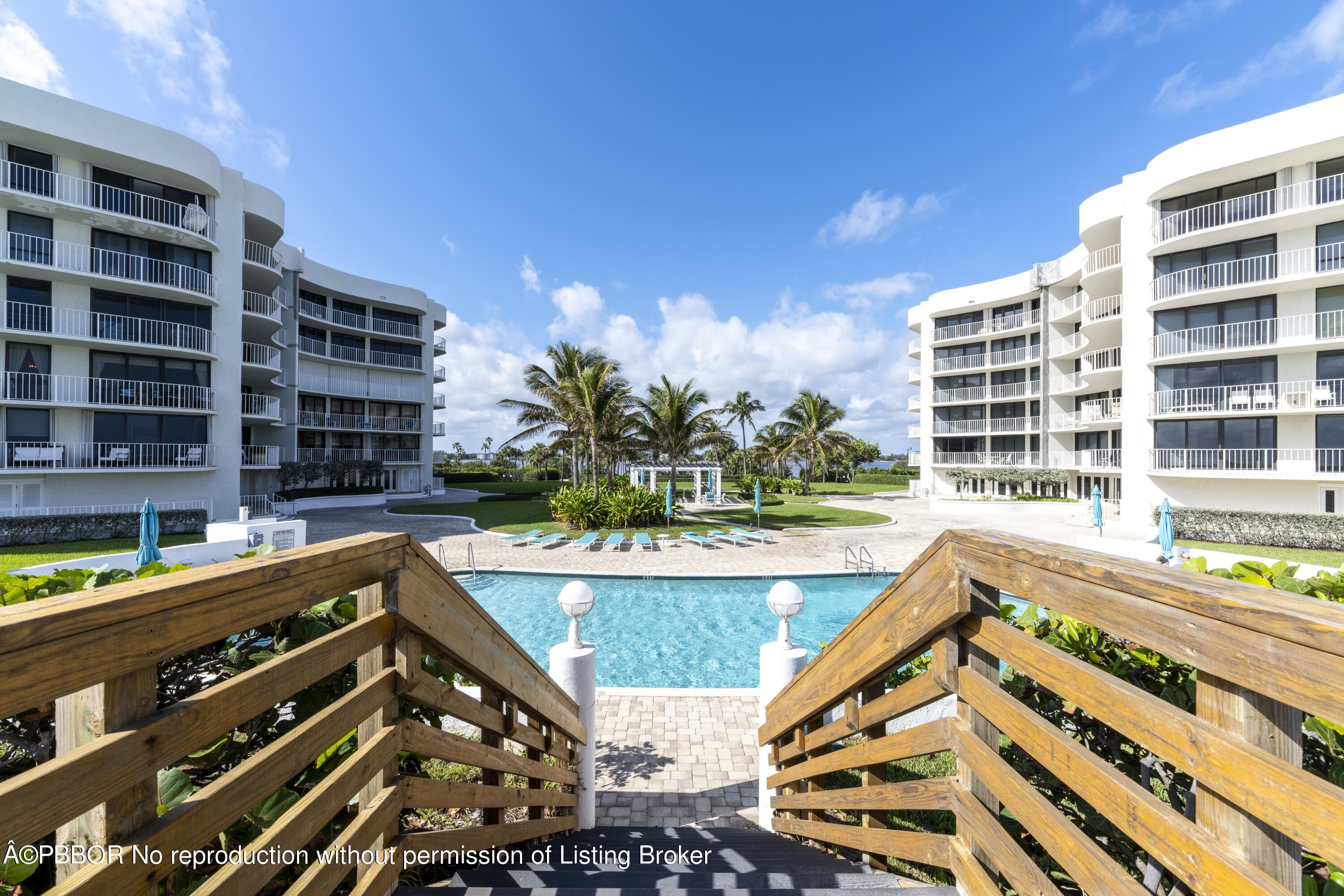 a view of building with swimming pool and patio