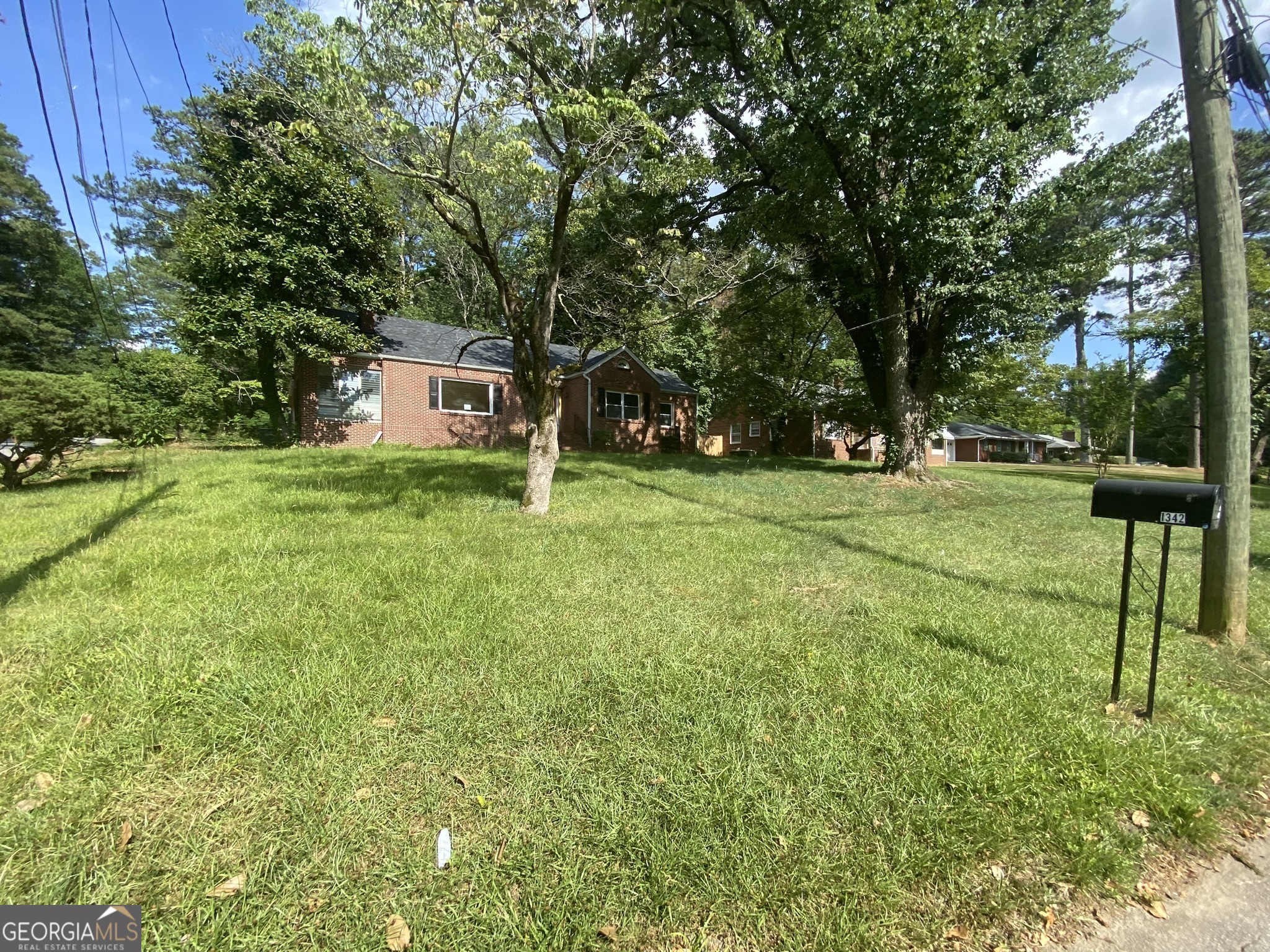 a house view with a play ground in front of it