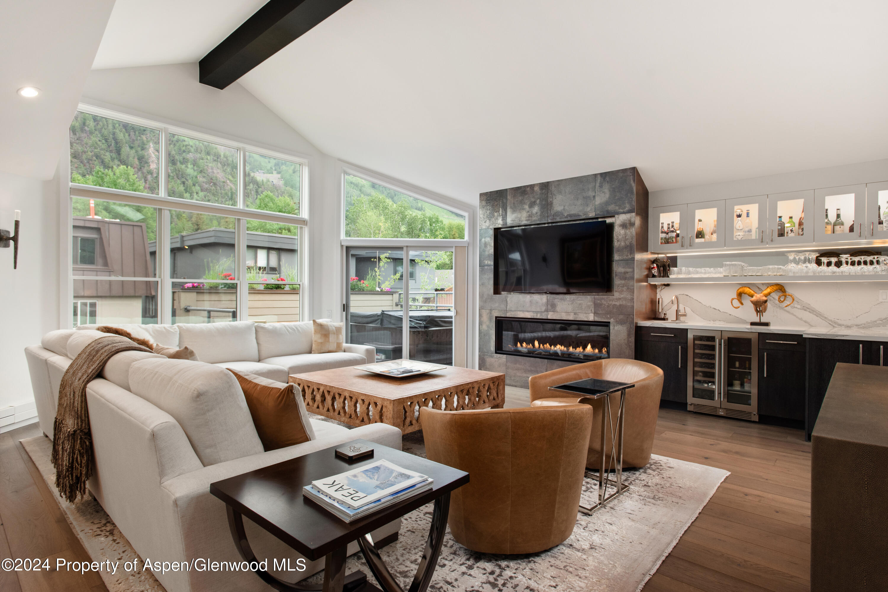 a living room with furniture flat screen tv and a fireplace