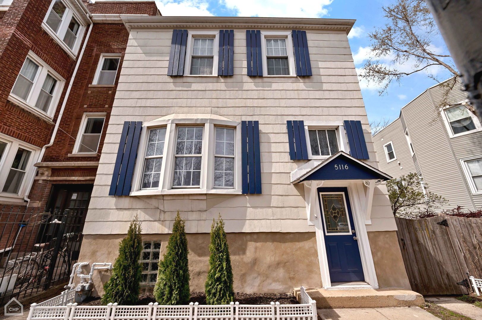 a front view of a house with many windows