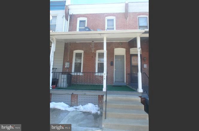 a view of a brick house with a yard