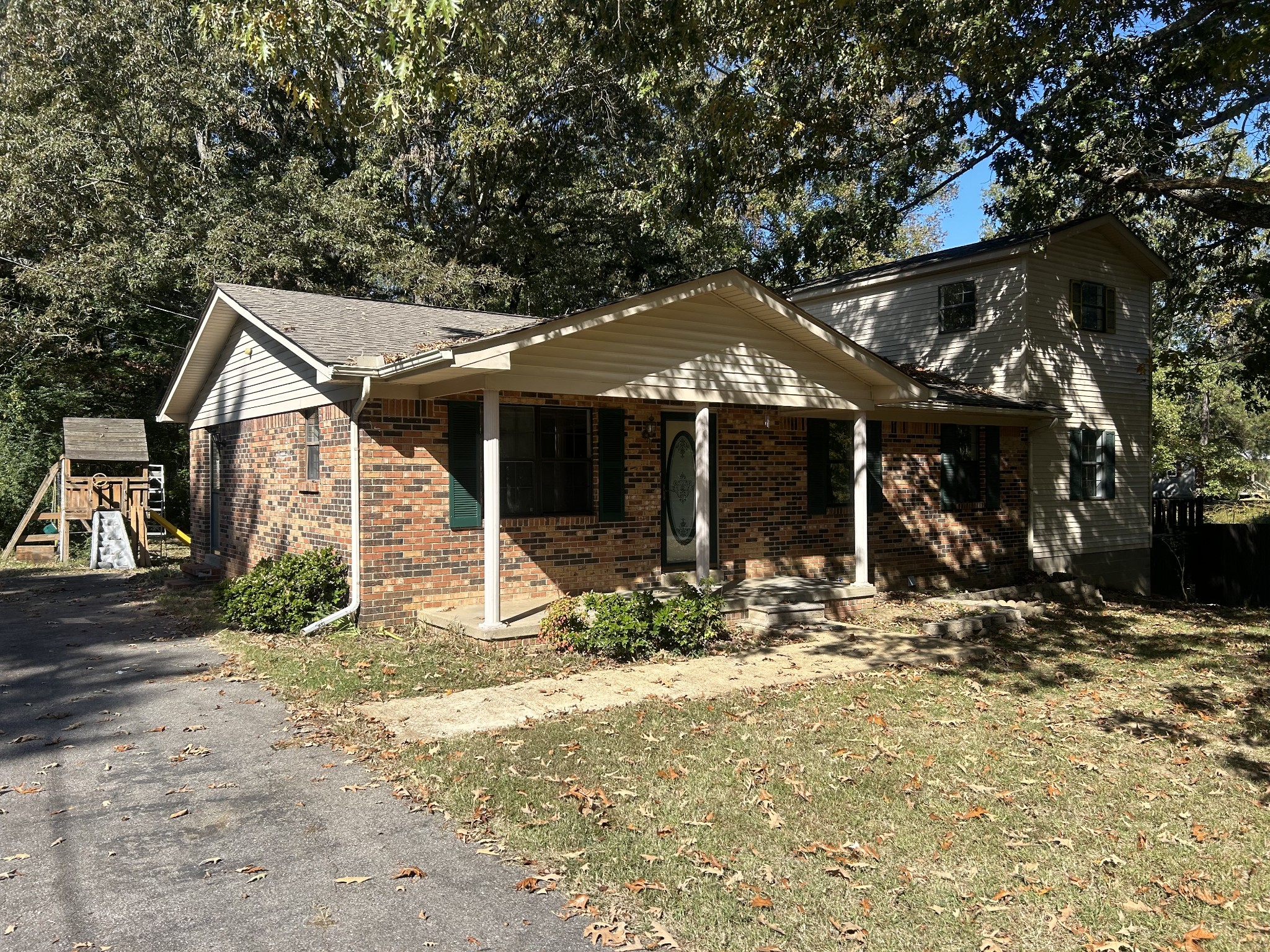 a view of a house with a tree in the yard