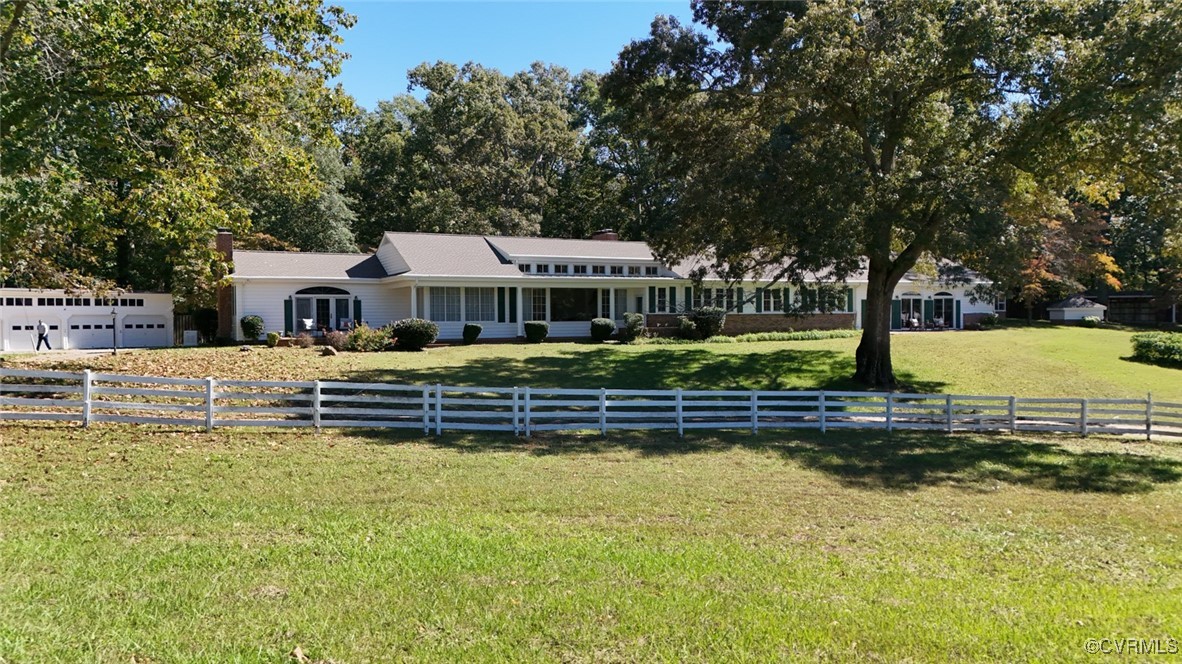 a front view of a house with a yard table and chairs