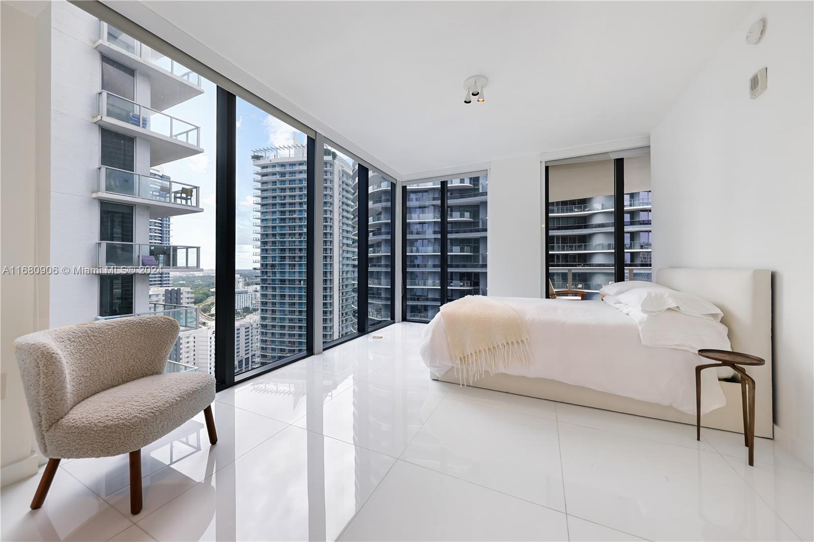 a large bed sitting in a bedroom next to a window