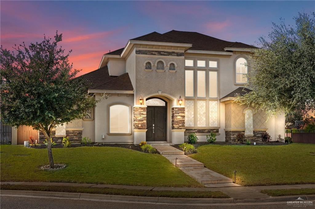 a front view of a house with a yard