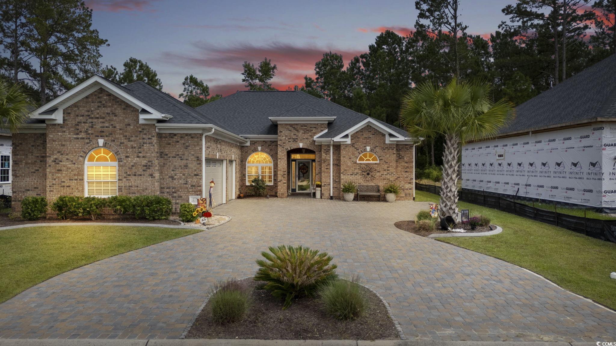 View of front of house featuring a garage and a ya