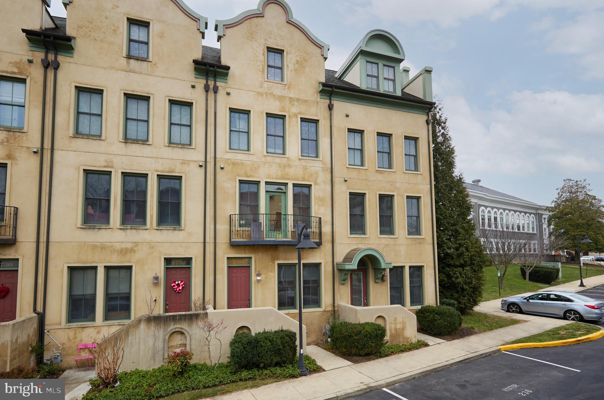 a front view of a residential apartment building with a yard