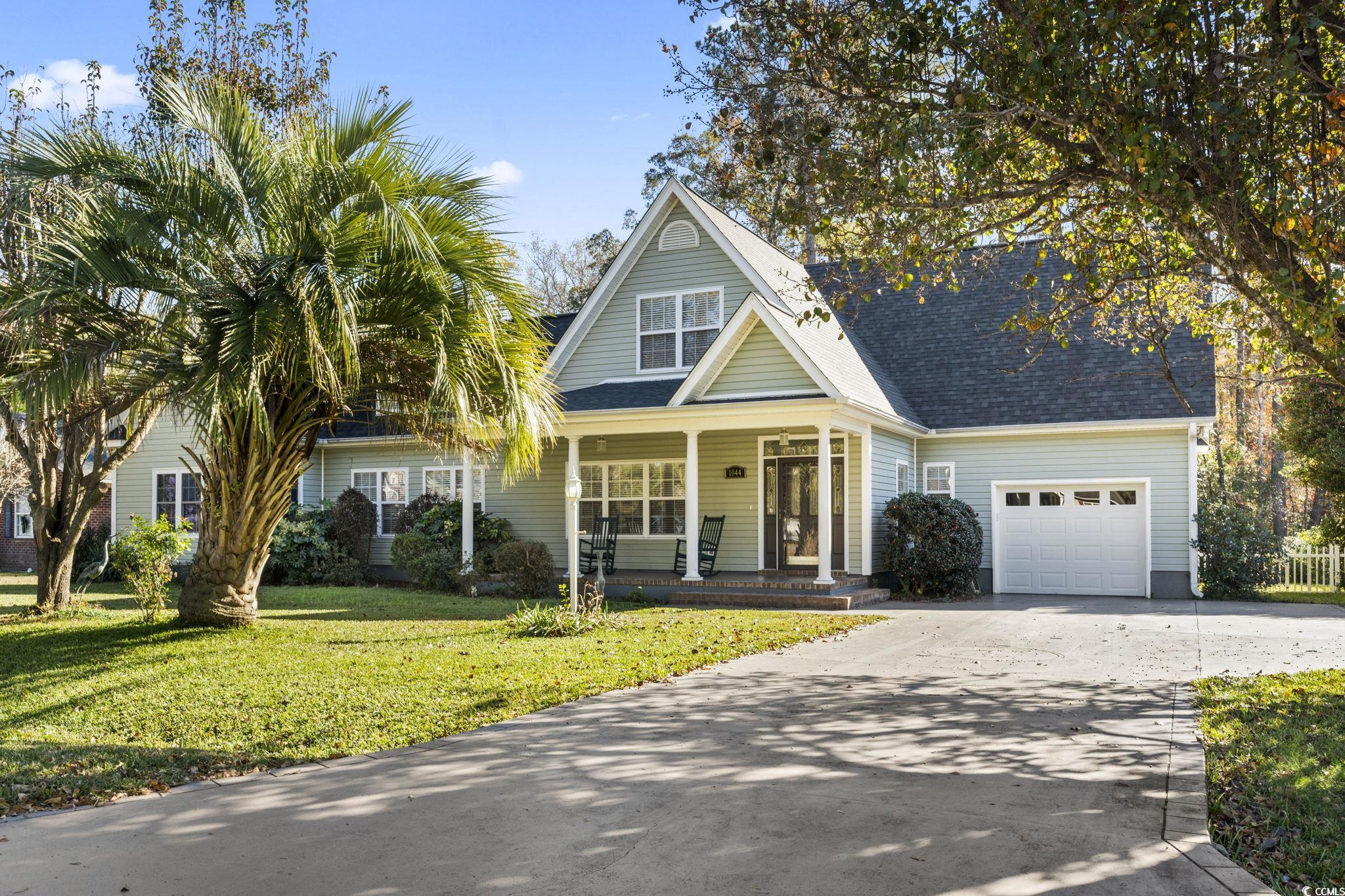 View of front of house featuring a porch, a garage