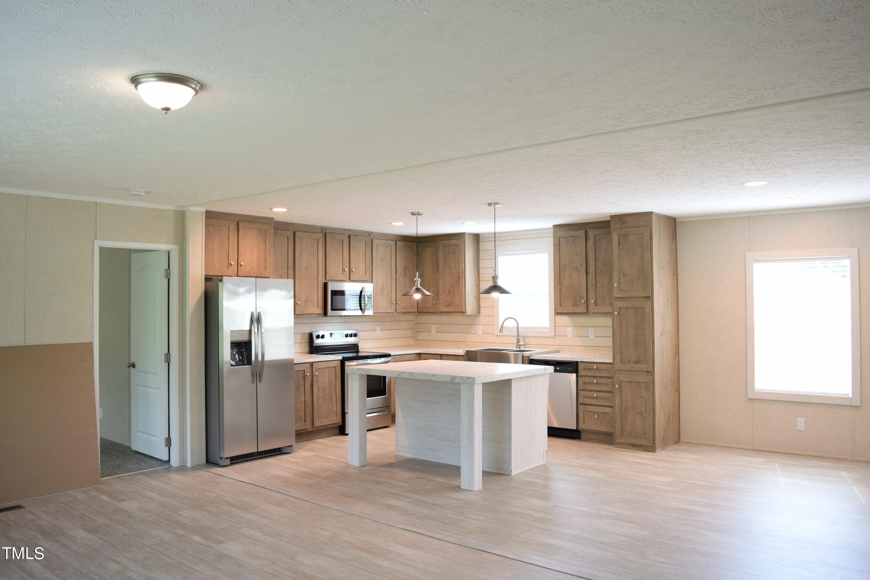 a kitchen with stainless steel appliances granite countertop a refrigerator and a sink