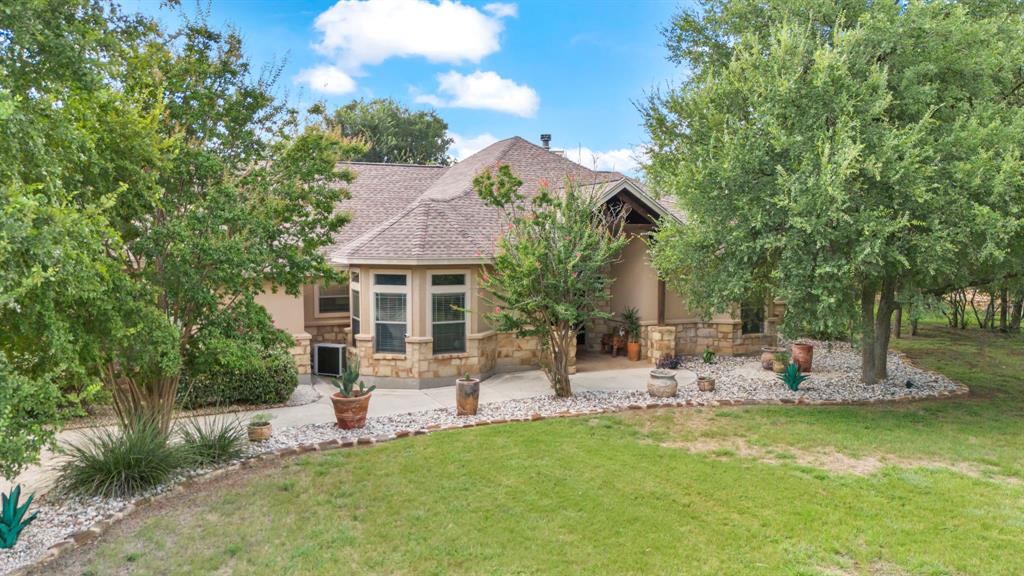 a view of a house with backyard porch and sitting area