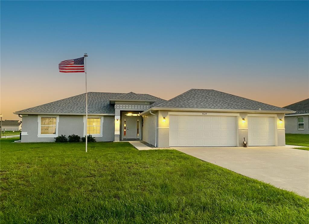 a front view of a house with a yard and garage