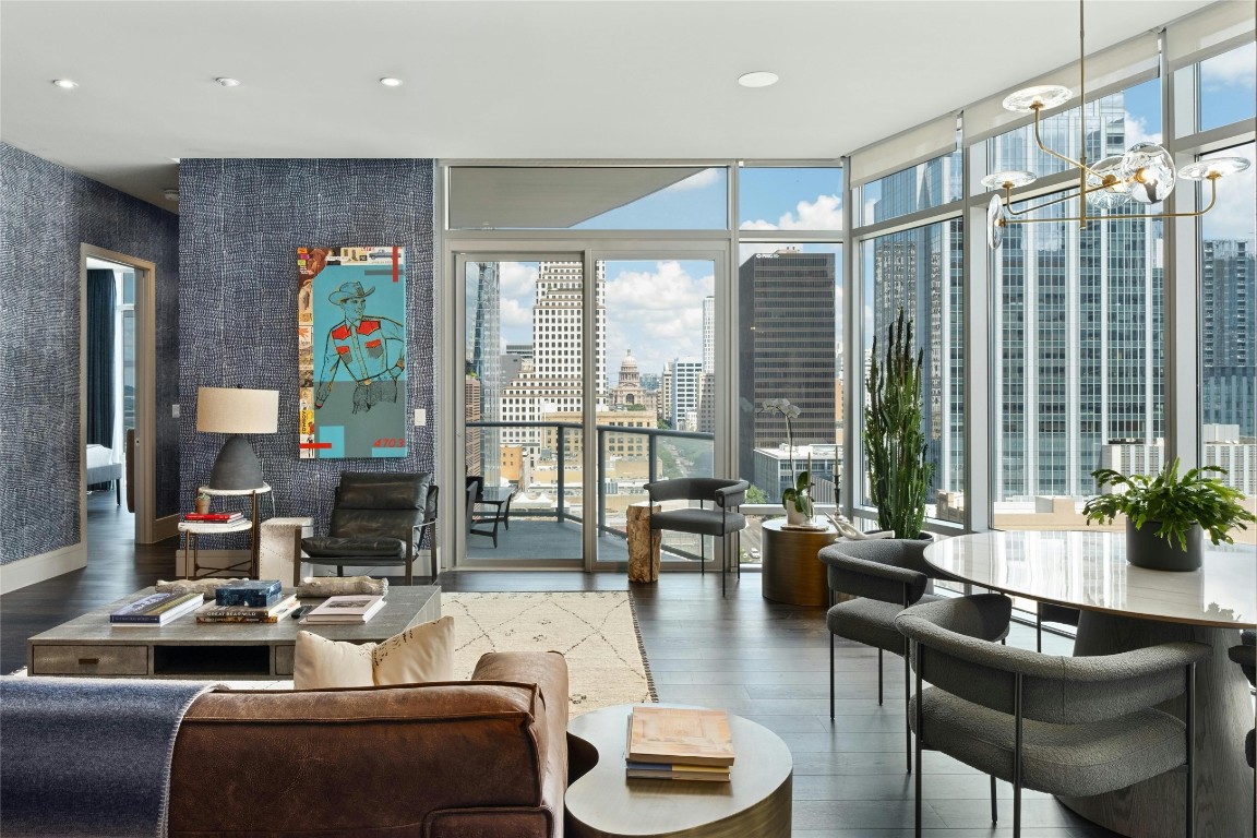 a living room with furniture and floor to ceiling windows