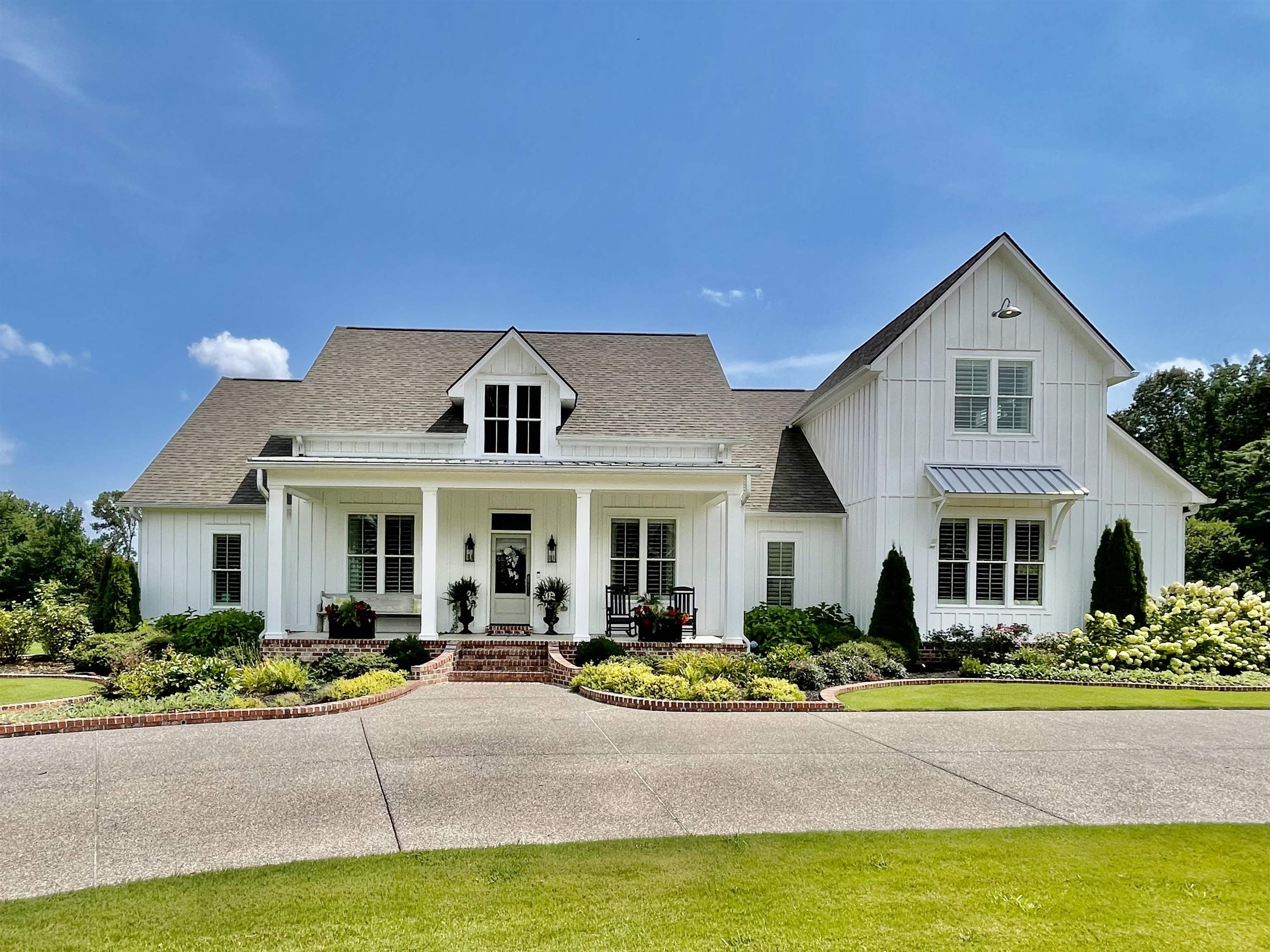 a front view of a house with swimming pool and porch