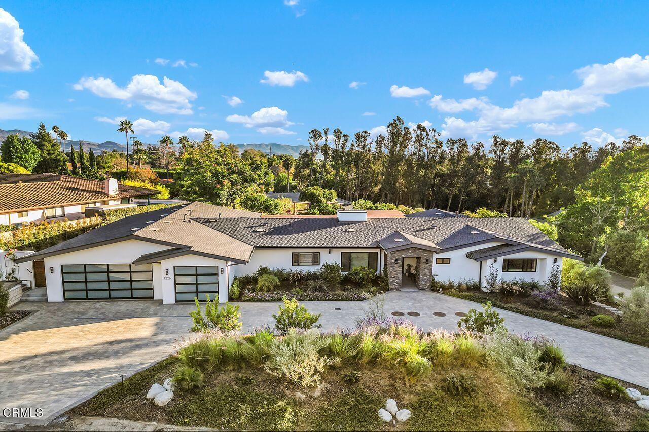 a aerial view of a house with swimming pool and garden