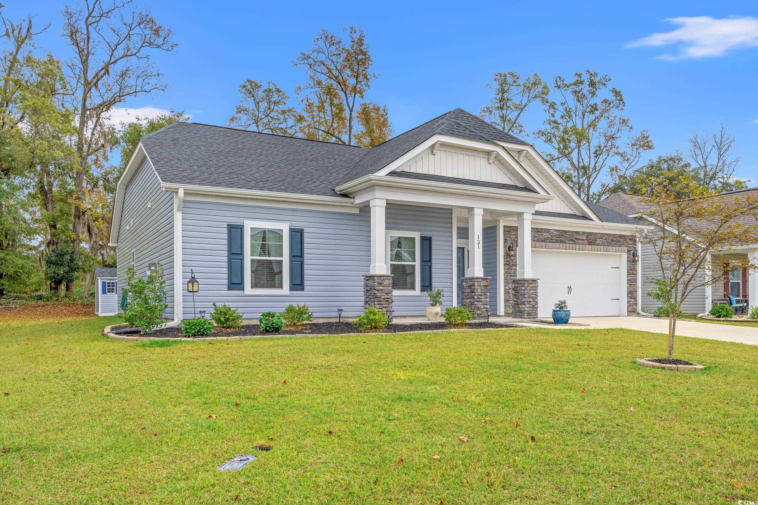 Craftsman inspired home featuring a garage and a f