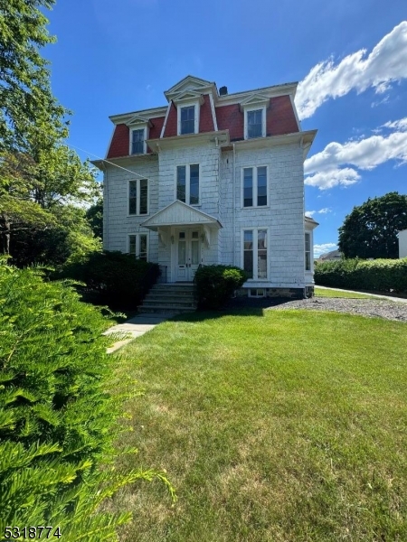 a front view of a house with a garden