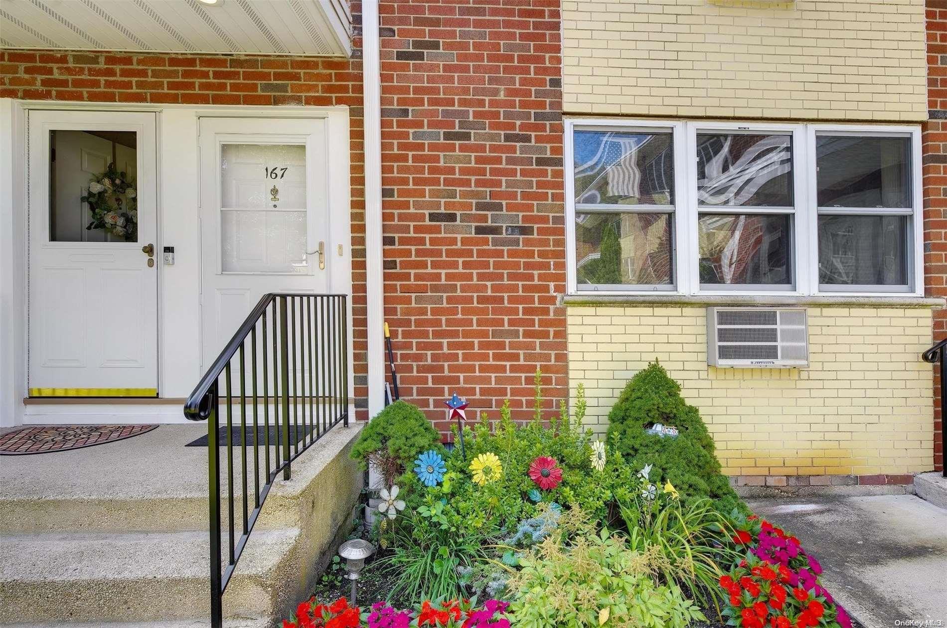 a view of a house with a flower garden