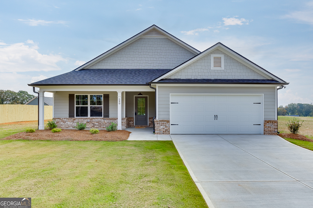 a front view of a house with a yard and sitting area