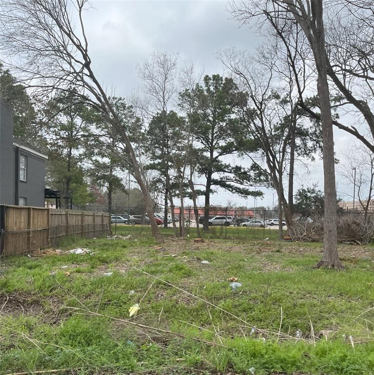 a backyard of apartments with large trees