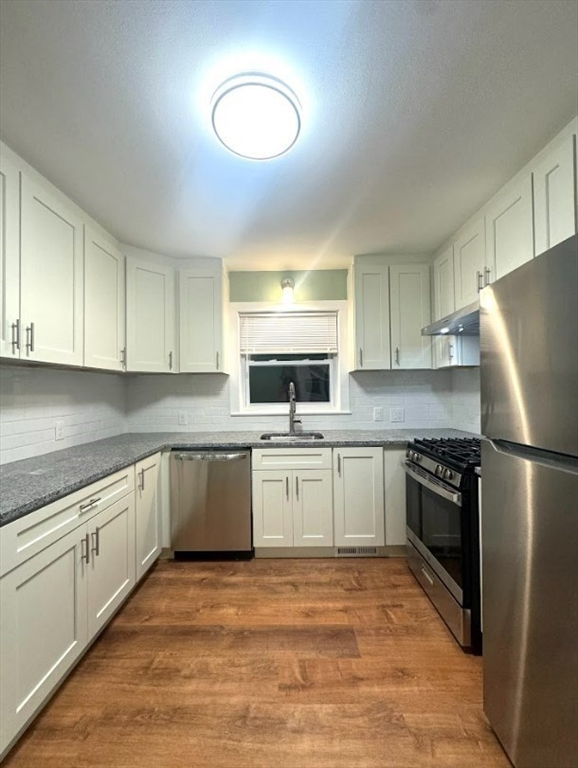 a kitchen with a refrigerator stove and sink