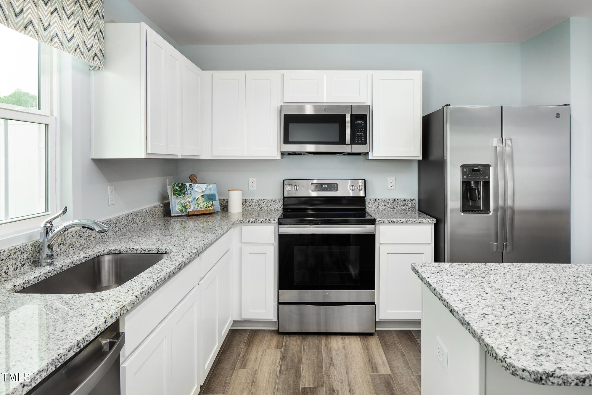 a kitchen with a sink stove and refrigerator