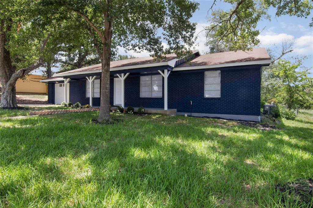 a brick house with a yard