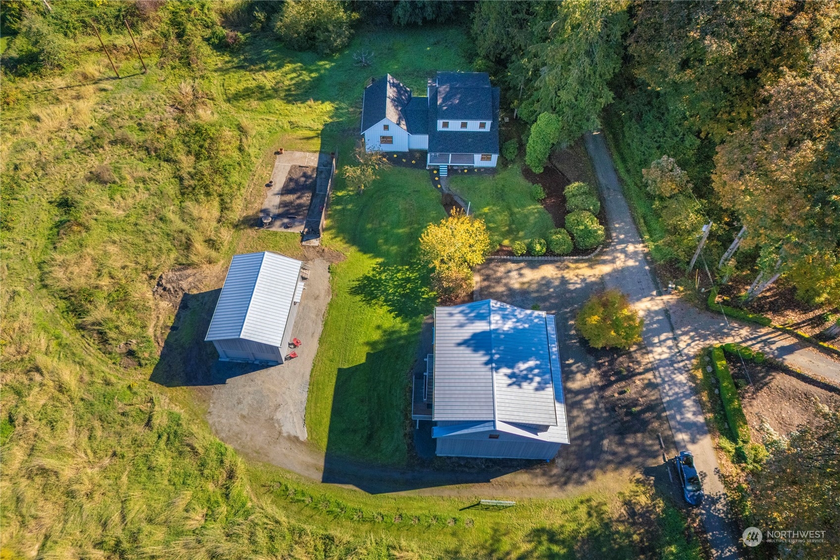 an aerial view of a house with a yard and lake view