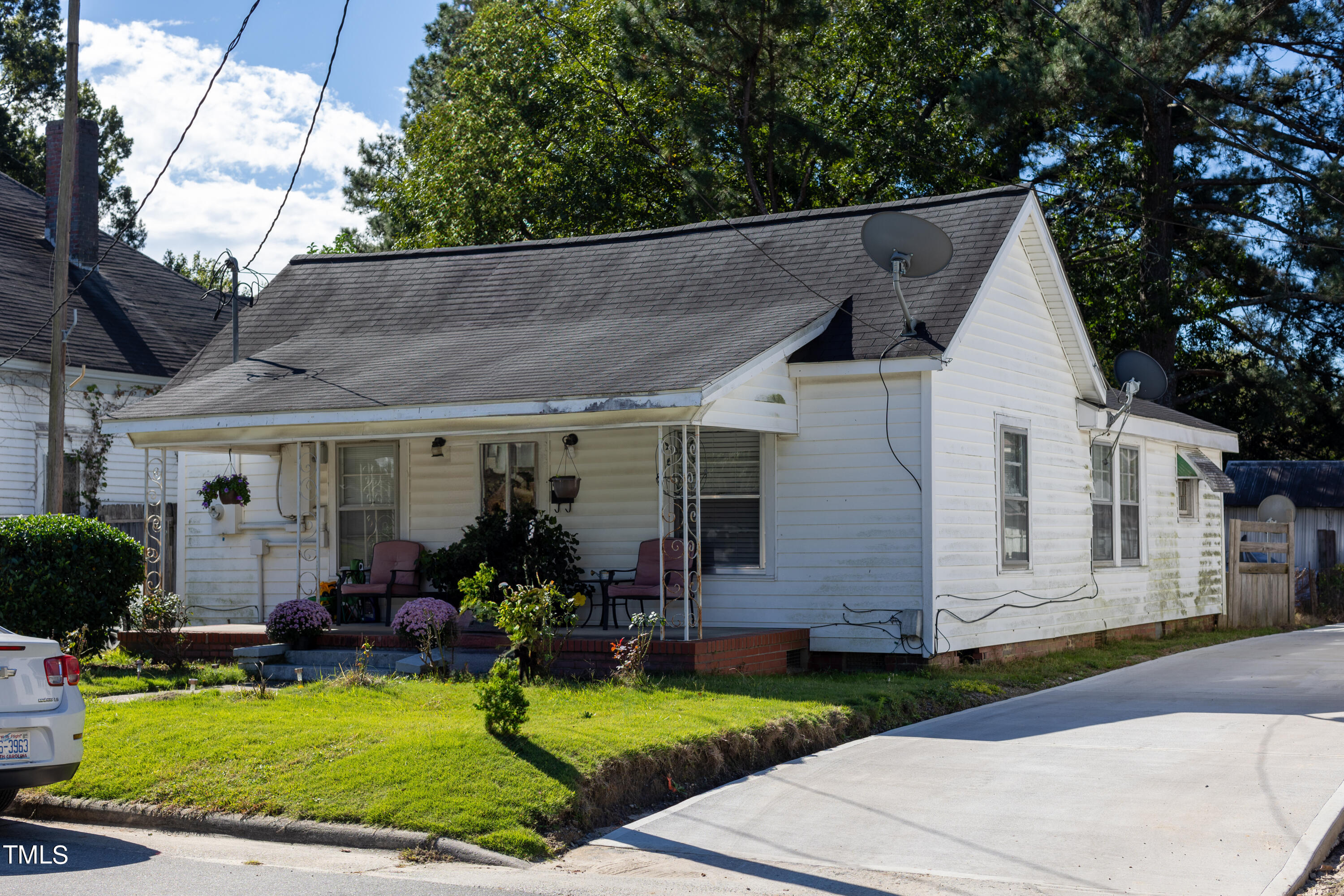 a front view of a house with garden and porch