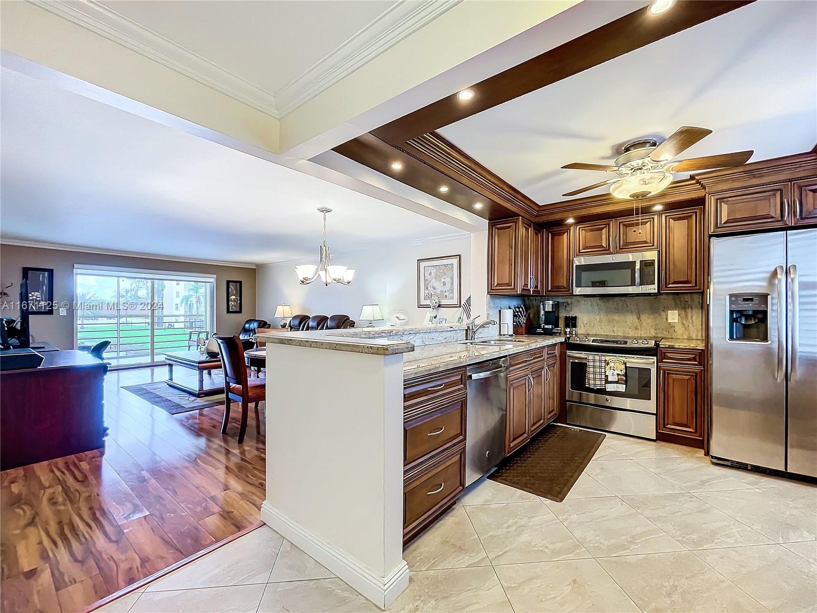 a kitchen with a sink appliances and cabinets