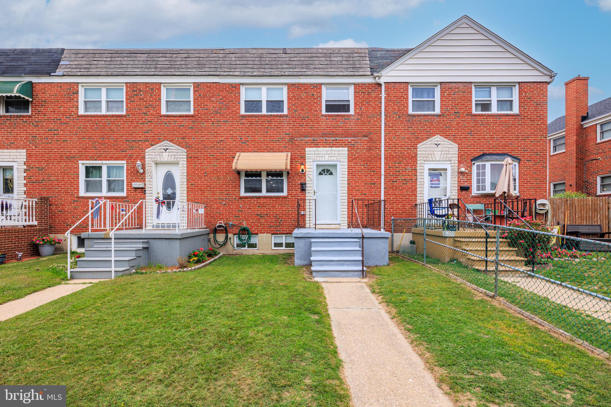 a front view of house with yard and outdoor seating