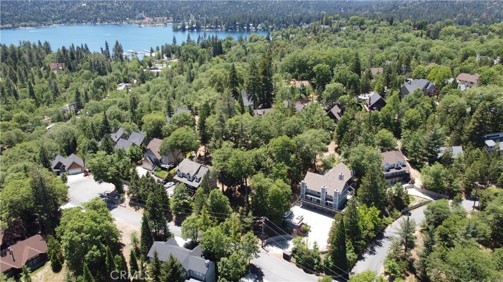 an aerial view of a house with a yard and outdoor seating