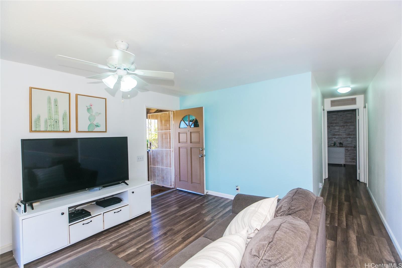 a bedroom with furniture and a flat screen tv